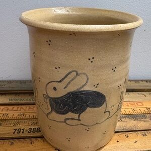 Tan ceramic vase with rabbit design